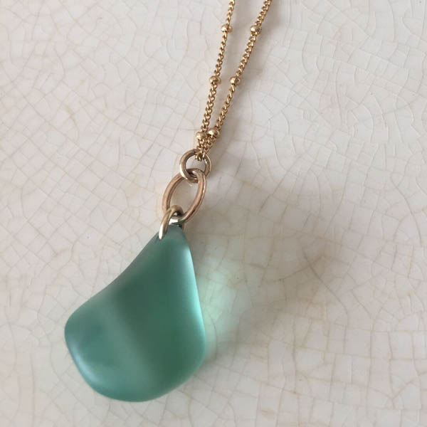 Sea glass pendant on a long gold satellite chain